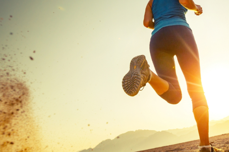 Chiropractor adjusting a male runner’s back to improve athletic performance and prevent injury.